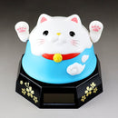 Decorative cat figurine with a blue background on a gray surface.