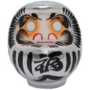 Silver daruma doll.
