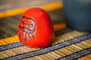 Daruma paperweight.