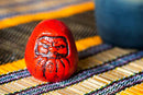 Daruma paperweight.
